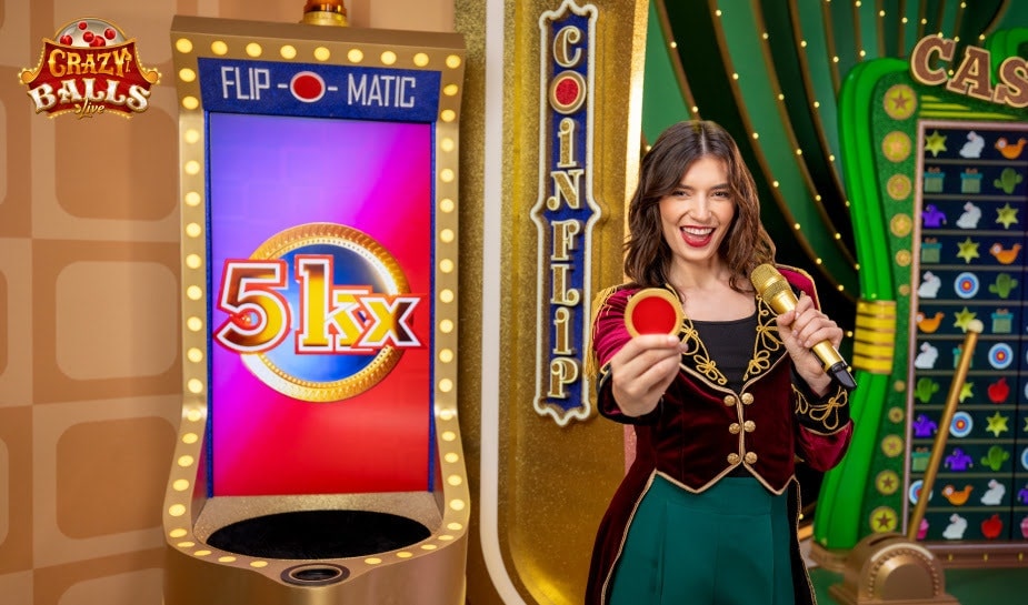 A game show set with a smiling host wearing a red and black outfit, holding a microphone and a red ball. The centerpiece is a large "Flip-o-Matic" display showing "51x" in bright colors. Various game elements and colorful backgrounds are visible.