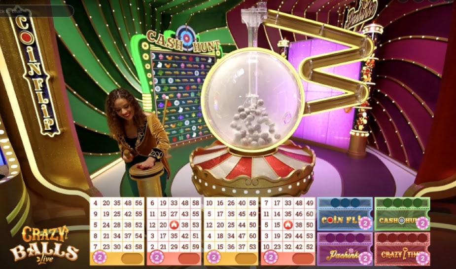 A complex game interface showing multiple number grids, a large transparent sphere filled with bouncing balls, and a host interacting with game elements. The scene is brightly lit with green and purple hues, featuring "Cash Hunt" and "Coin Flip" game options.